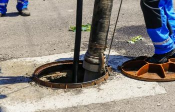 worker pumping a septic tank